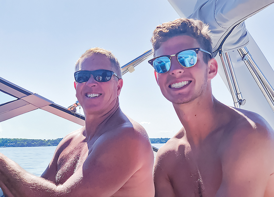 Dyer dad and son smiling on the boat