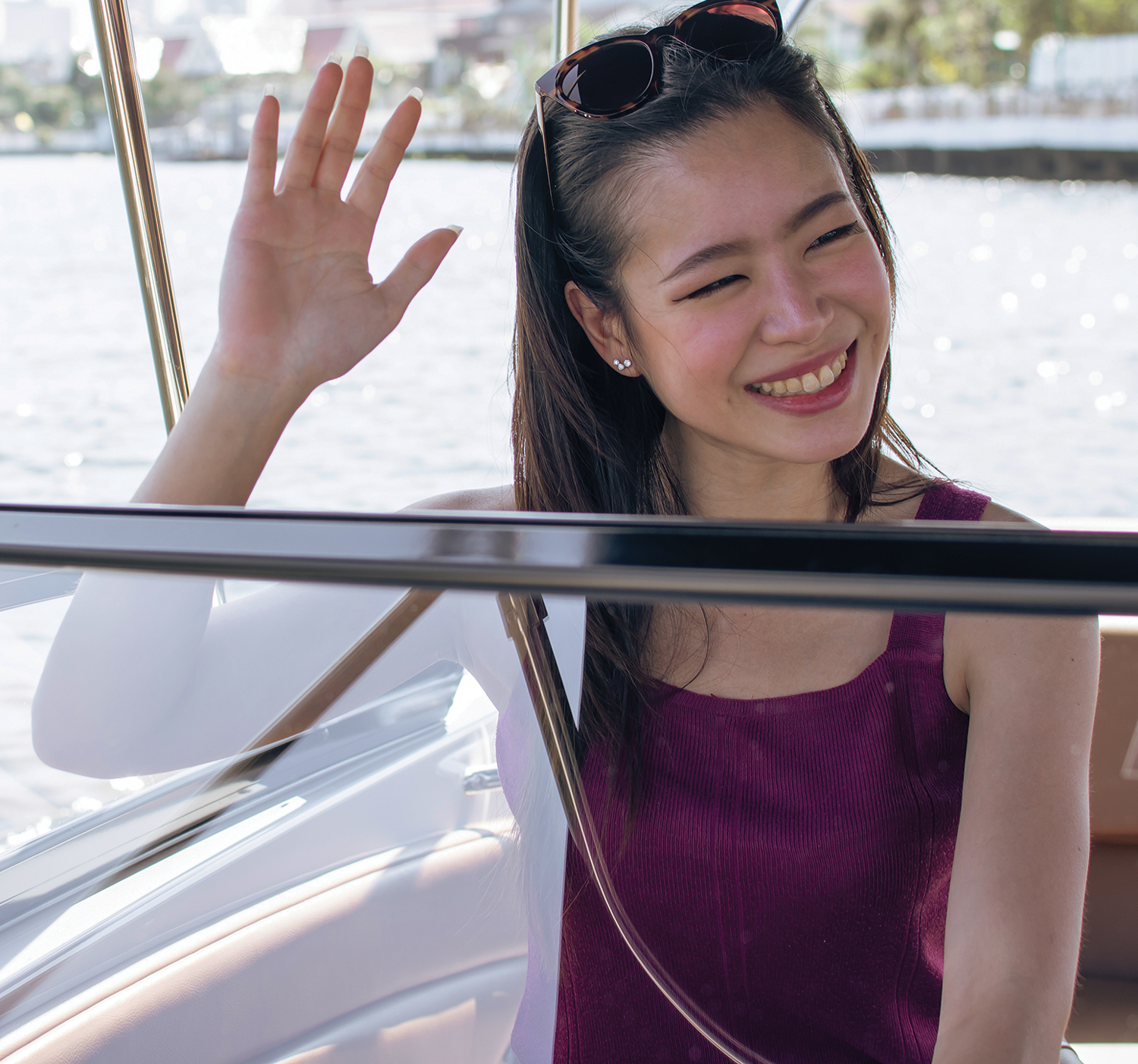 Woman waving hello on a boat