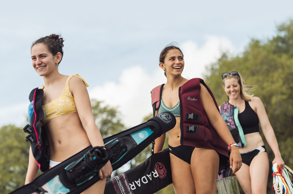 group of girls carrying water ski supplies