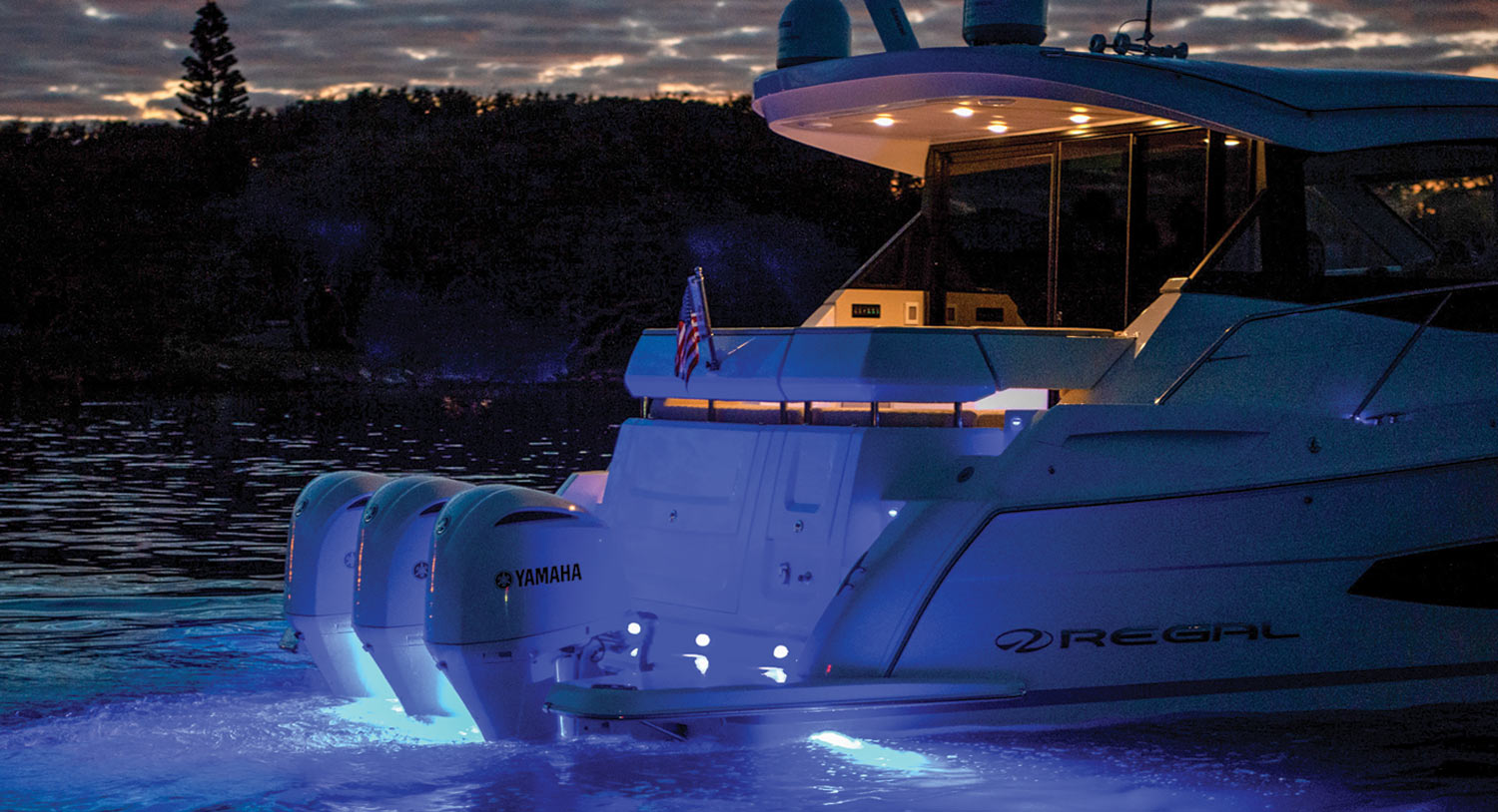 a boat on water at night with lights on