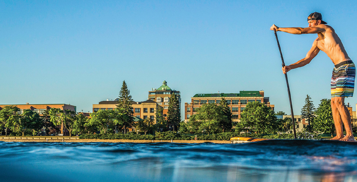man paddle boarding in Traverse City, Mich.
