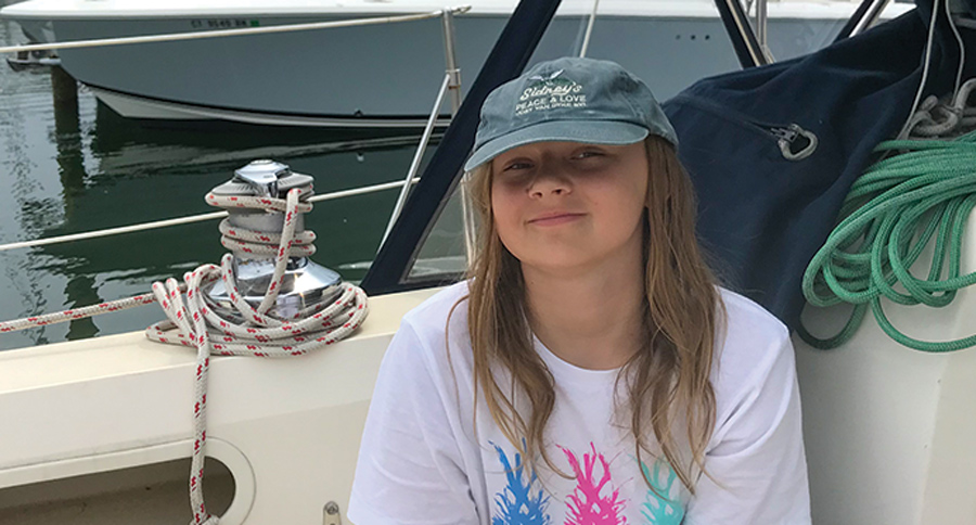 kid in hat sitting on boat