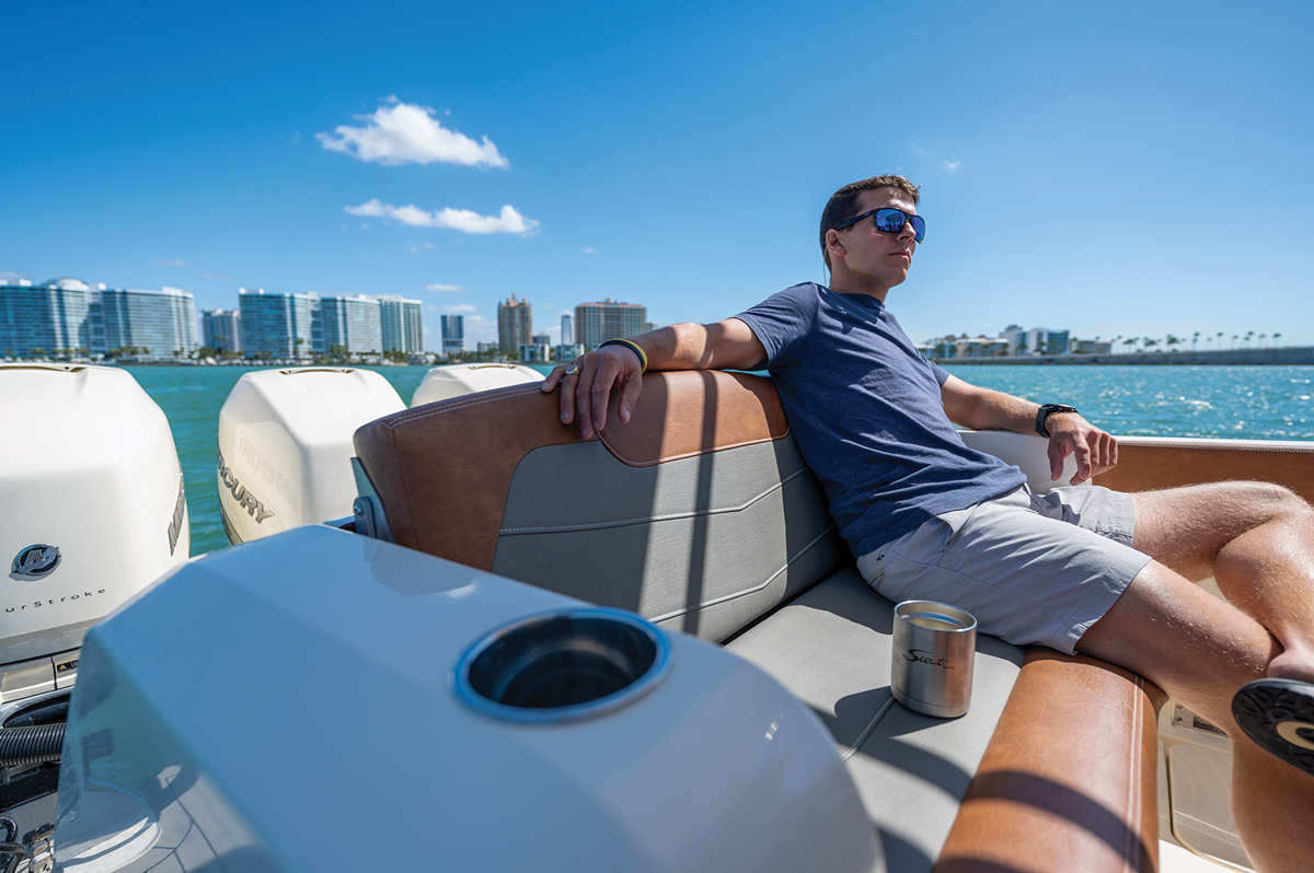 man with sunglasses sitting on boat